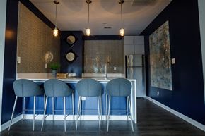 Decatur apartment for rent - a kitchen with blue chairs in front of a bar with a sink