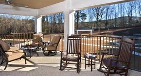 Stone Mountain apartment for rent - a porch with rocking chairs and a table and a pool
