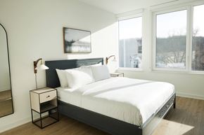 Philadelphia apartment for rent - a bedroom with a large bed and three windows