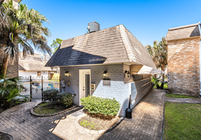 Metairie apartment for rent - A house with a brick chimney and a white front door.