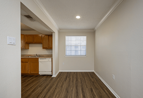 Metairie apartment for rent - A kitchen with wooden cabinets and a white dishwasher.