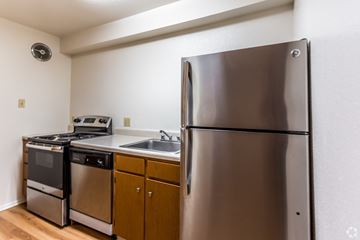 Metairie apartment for rent - A kitchen with a stainless steel refrigerator, dishwasher, and oven.