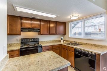 Terrytown apartment for rent - a kitchen with granite counter tops and wooden cabinets