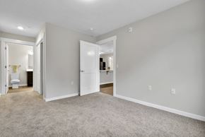 Lansing apartment for rent - A room with a carpeted floor and white walls.