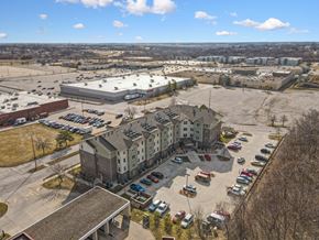 Des Moines apartment for rent - A parking lot with cars and a building in the background.