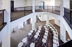 Newton apartment for rent - A room with a balcony and a long table with chairs.