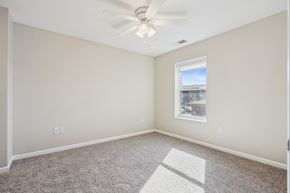 Grimes apartment for rent - A room with a ceiling fan and a window letting in light.