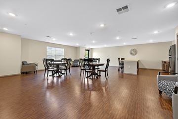 Cedar Rapids apartment for rent - A living room with a dining table and chairs.