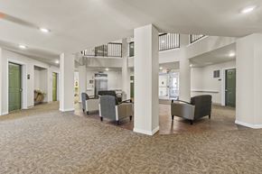 Des Moines apartment for rent - A spacious room with a carpeted floor and a balcony with a railing.