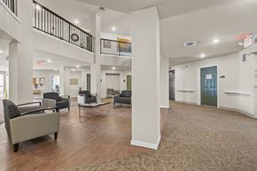 Des Moines apartment for rent - A spacious living room with a staircase and a green door.