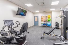 Mt Union apartment for rent - a gym with exercise equipment and a tv in the corner of a room