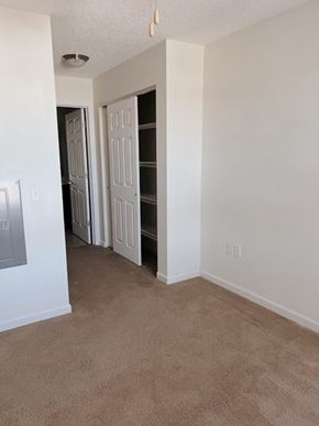 Clinton apartment for rent - A room with a carpeted floor and a white door.