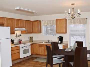 Altoona apartment for rent - A kitchen with wooden cabinets and a white refrigerator.
