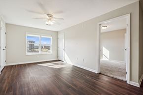 Grimes apartment for rent - A room with a ceiling fan and a large window.
