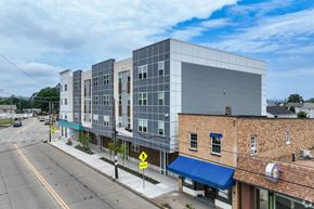 Monaca apartment for rent - A street view of a city with a large building on the right.