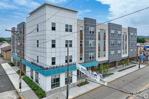 Monaca apartment for rent - A large white building with a blue stripe on the bottom.