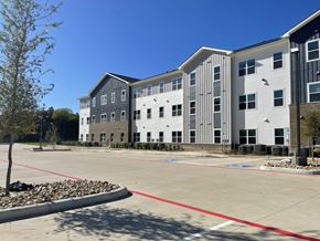 Lufkin apartment for rent - A parking lot in front of a multi-story building.