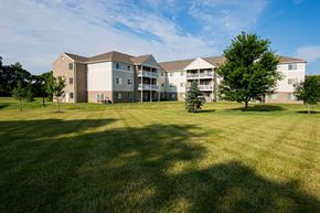 Dayton apartment for rent - A large grassy field in front of a building.