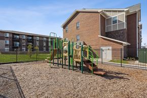 Grimes apartment for rent - A playground with a slide and a building in the background.