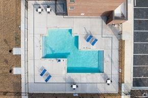 Arlington apartment for rent - A swimming pool surrounded by a concrete floor and walls.