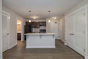 Jackson apartment for rent - A kitchen with a white island and wooden floors.