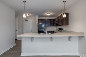 Jackson apartment for rent - A kitchen with a white island and black cabinets.