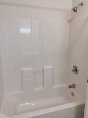 Clinton apartment for rent - A white bathtub with a shower head and faucet.