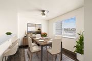 Post Falls apartment for rent - Bright dining area with a large window on the right wall, ceiling fan, and breakfast bar to the left. Staged with a dining table, chairs, plants, and art.at Clearwater, Idaho