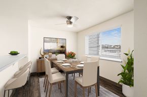 Post Falls apartment for rent - Bright dining area with a large window on the right wall, ceiling fan, and breakfast bar to the left. Staged with a dining table, chairs, plants, and art.at Clearwater, Idaho