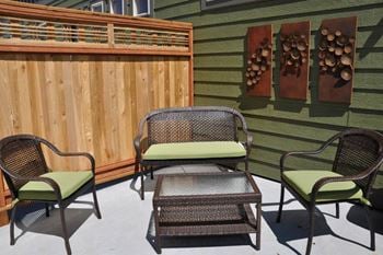A patio with chairs and a table on a patio