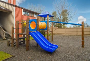 A playground with a blue slide and yellow