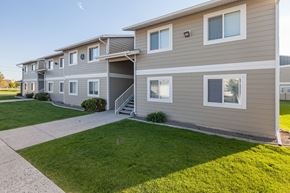 Billings apartment for rent - a sidewalk in front of a building with grass at Shiloh Glen, Billings Montana