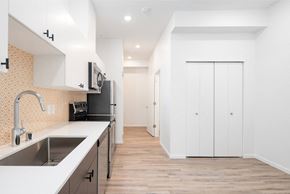 Seattle apartment for rent - a renovated kitchen with white cabinets and a sink at The Loop at Green Lake, Seattle, WA, 98115