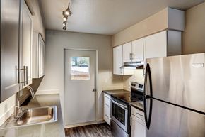 Poulsbo townhouse for rent - a kitchen with stainless steel appliances and white cabinets at Woodcreek, Poulsbo, WA