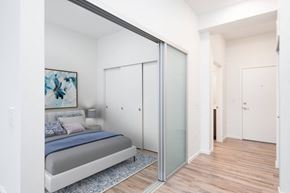 Seattle apartment for rent - a bedroom with a bed and a sliding glass door
