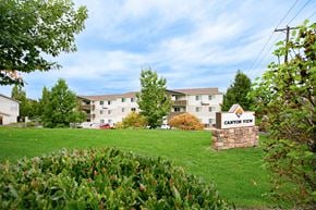 Lewiston apartment for rent - Grassy field and landscaping with Canyon View apartments and sign in the distance. at Canyon View, Idaho, 83501