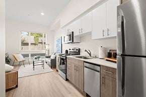 University Place apartment for rent - a kitchen with stainless steel appliances and white cabinets at The Duo, Washington