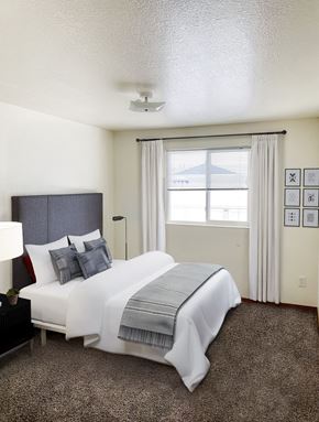 Billings apartment for rent - a bedroom with a bed and a window with red curtains at Shiloh Glen, Montana
