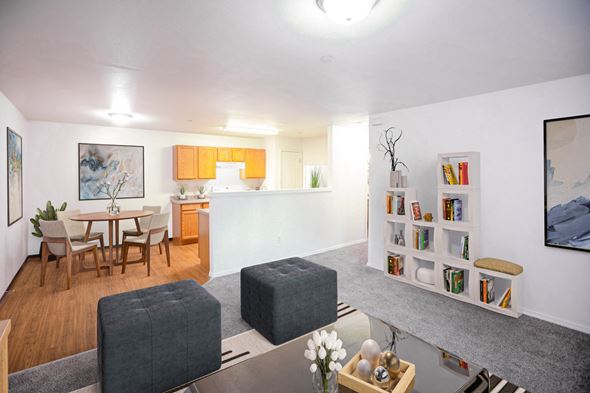 Lewiston apartment for rent - Big open living area with living room, dining area and kitchen with half wall visible. Taupe carpet in living room and faux wood flooring in dining and kitchen areas.at Canyon View, Idaho