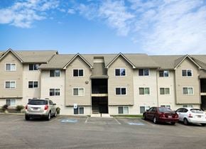 Post Falls apartment for rent - Clearwater Apartments exterior shot with community parking in front.at Clearwater, Post Falls, ID 83854