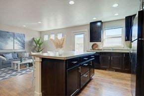 Bozeman townhouse for rent - a kitchen with a center island and a living room  at Copper Pines, Bozeman, Montana