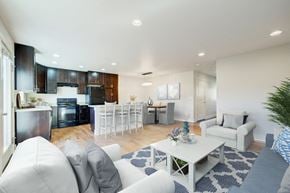 Bozeman townhouse for rent - a living room and kitchen with white couches and a table at Copper Pines, Montana