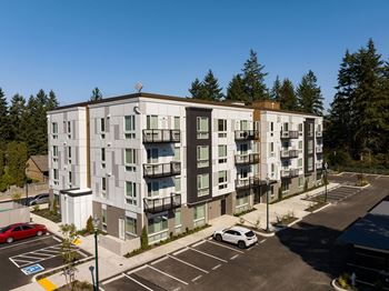 An aerial view of an apartment building in a parking lot