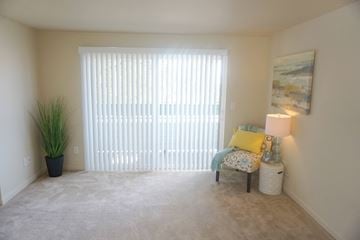 Renton apartment for rent - a living room with a large window and a chair