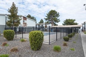 Kennewick apartment for rent - A swimming pool that's surrounded by a black wrought iron fence at Wildflower, Washington