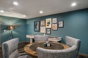 Wenatchee apartment for rent - a game room with blue walls and a round table with three chairs at Cedarwood, Wenatchee, WA 98801
