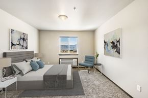 East Wenatchee apartment for rent - a bedroom with a bed and a chair in a 555 waverly unit  at Altitude, East Wenatchee
