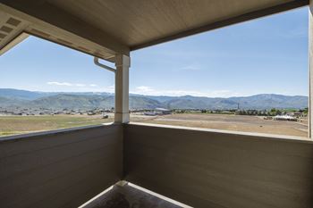 The view from the porch of a cabin with a view of the mountains