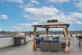 Seattle apartment for rent - a rooftop terrace with a gazebo and couches on a roof