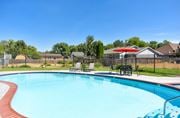 Boise apartment for rent - our resort style swimming pool is next to our yard with chairs and an umbrella